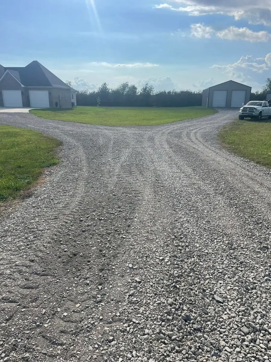 New gravel driveway and parking area between two shops