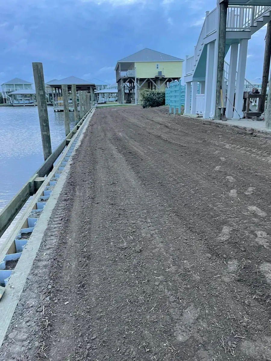 Graded dirt drive along a canal bulkhead