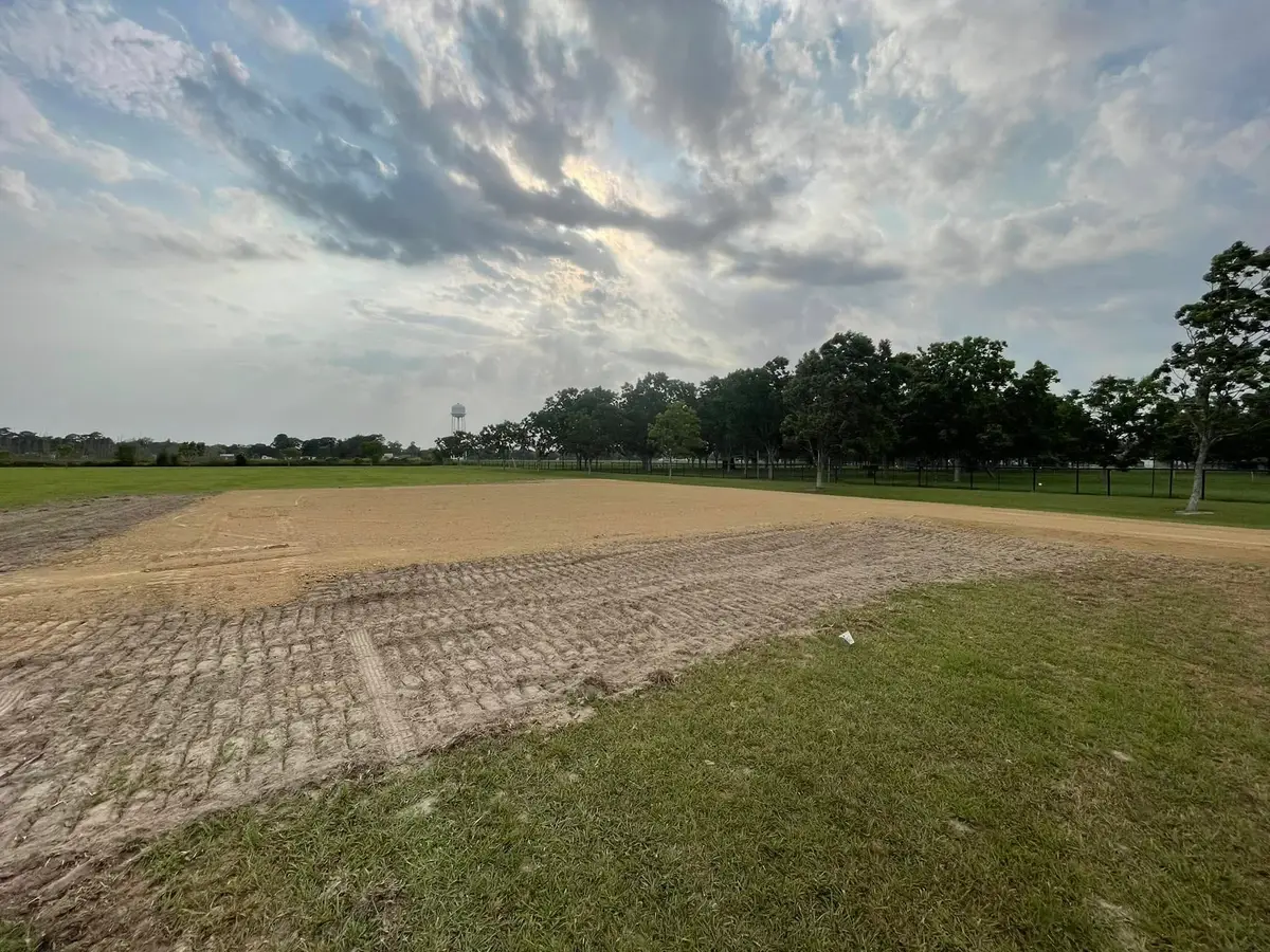 Compacted and graded field pad